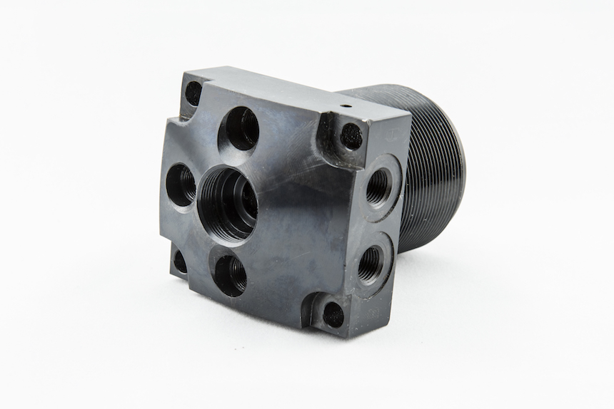 CNC machined link clamp with threaded bore and mounting features