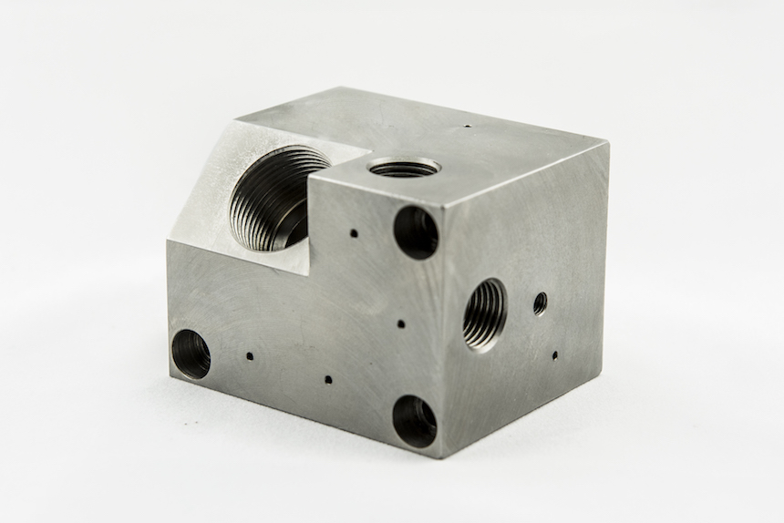 CNC machined hydraulic valve body with multi-face porting
