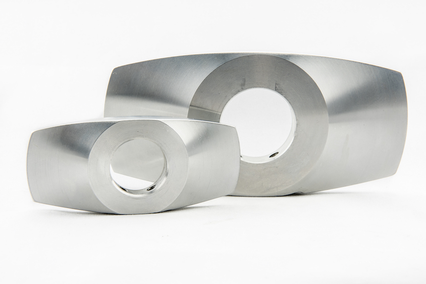 Precision CNC machined slinger components with through-bore features